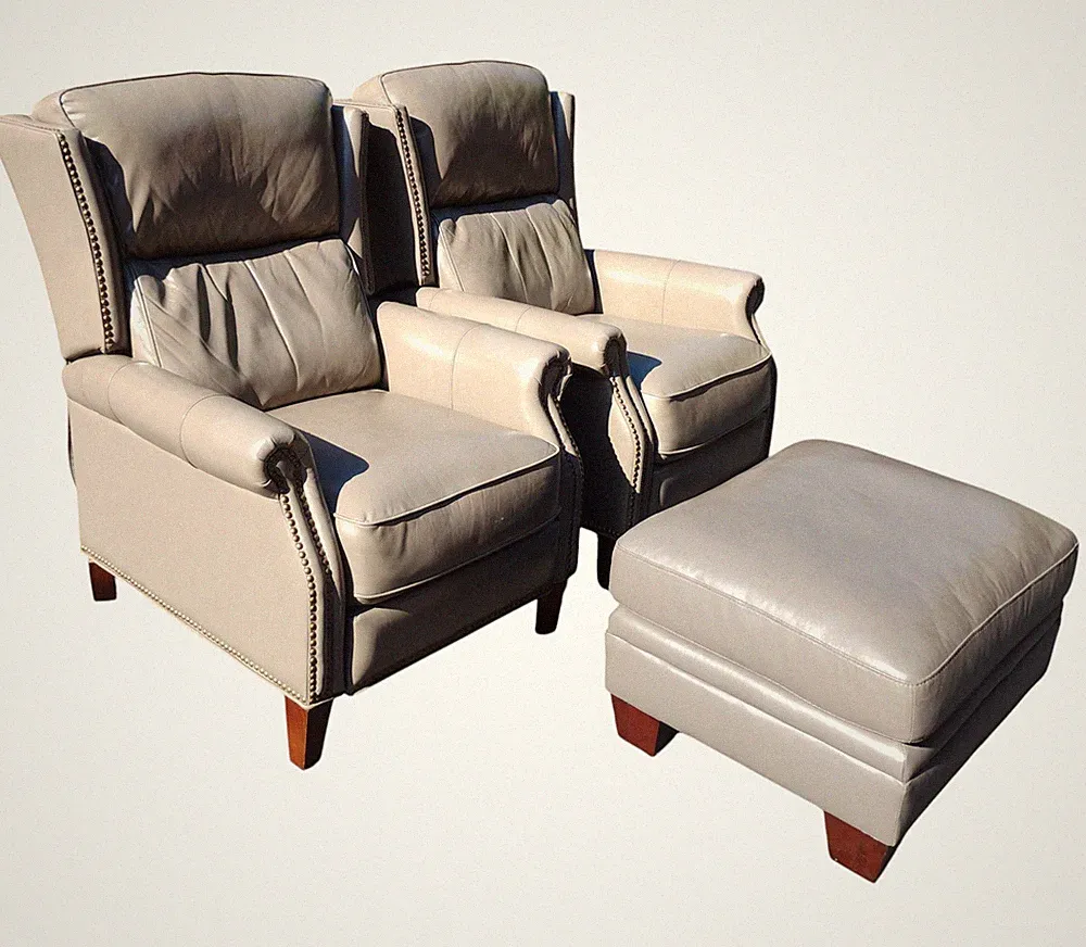 Elevate your space with this exquisite pair of Leather Recliners & Ottoman